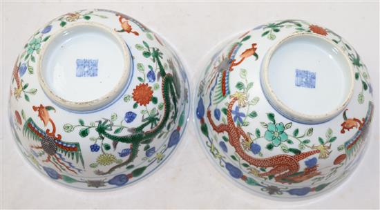 A pair of Chinese wucai dragon and phoenix bowls, Qianlong seal marks, late 19th/early 20th century, 18cm, small rim chips